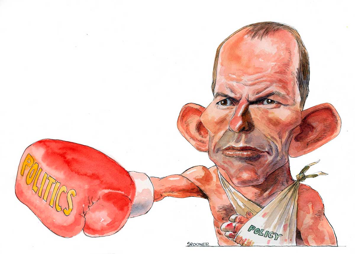 A colour cartoon depicting Tony Abbott as a boxer. He extends his right arm, which has a large red glove on its hand. On the glove is written 'POLITICS'. His other arm is in a sling. On the sling is written 'POLICY'. His expression is one of resolve and determination. - click to view larger image