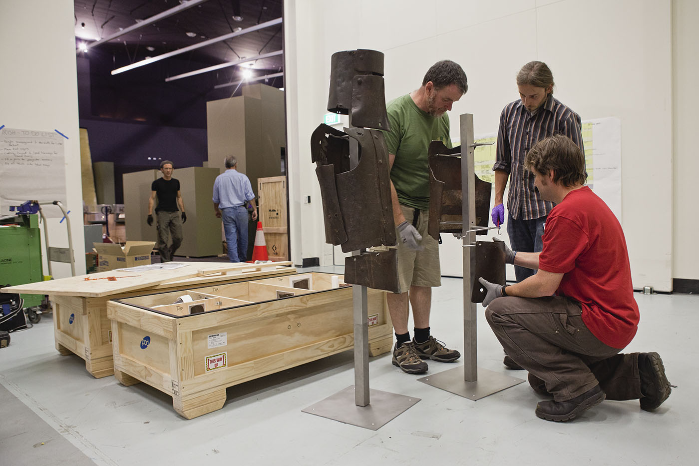 Staff working on installing armoury for an exhibition. - click to view larger image