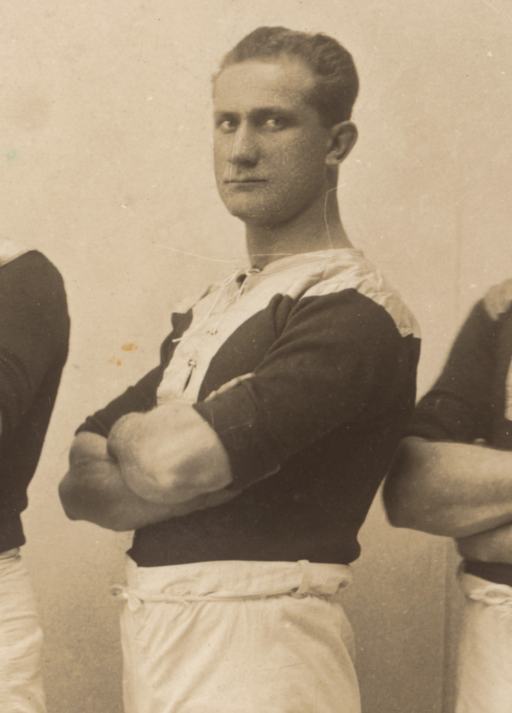 Portrait of a man in sports clothes, standing and folding his arms. - click to view larger image