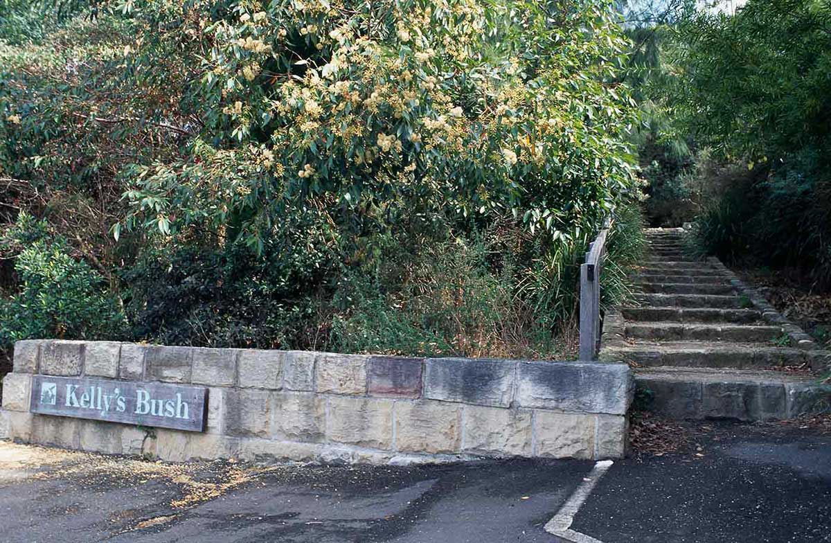 Garden featuring sandstone wall with sign that reads 'Kelly's Bush'.