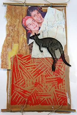 A completed collage featuring printed card, a map, a photograph of two girls and a kangaroo.