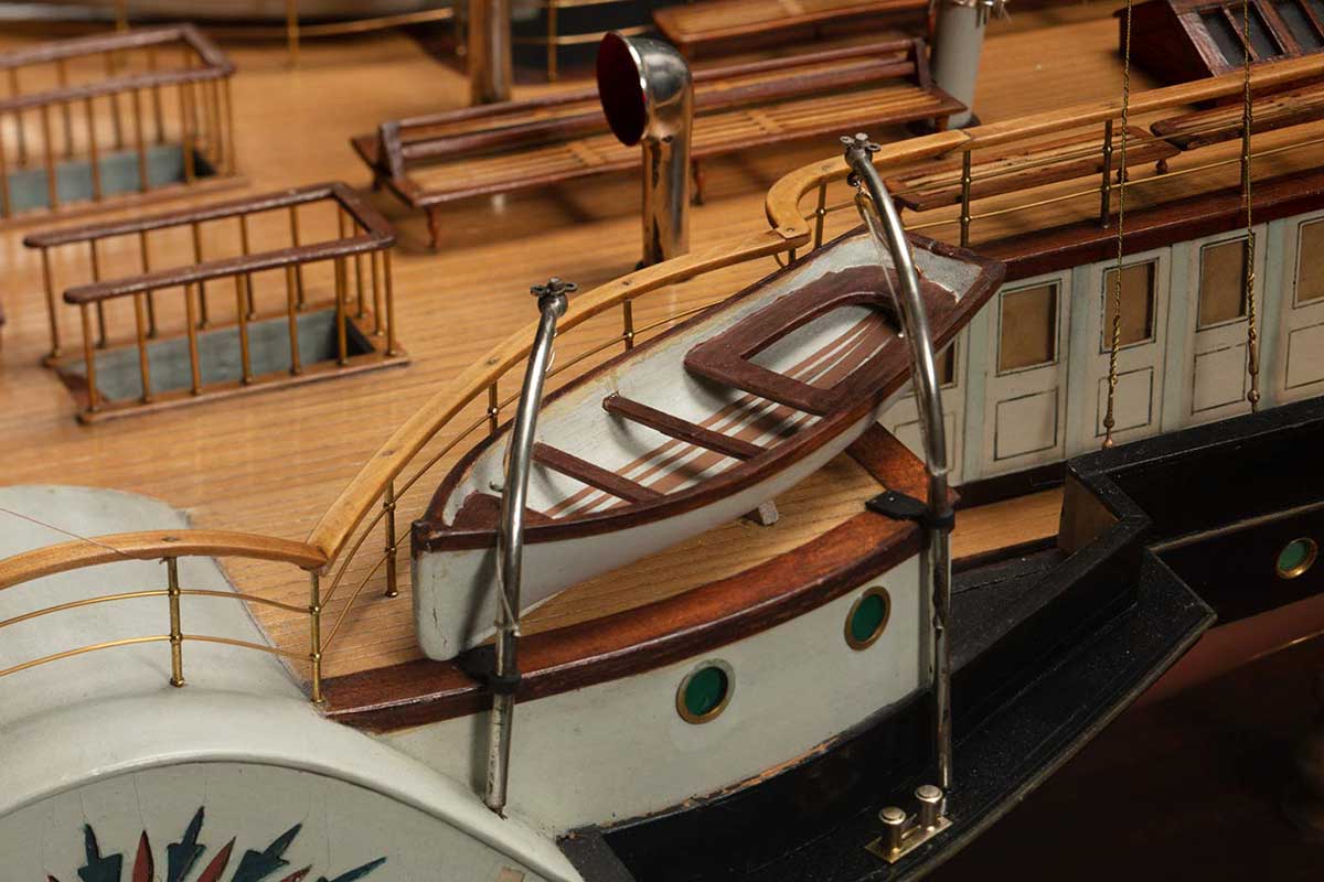 Detail of a model of a ship featuring a life boat. - click to view larger image