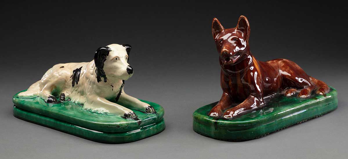 Two painted ceramic door stops in the form of a labrador retriever and a kelpie. - click to view larger image