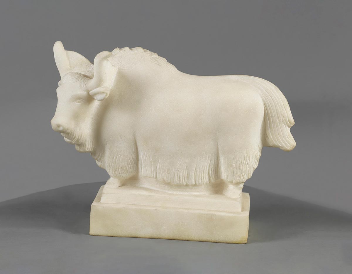 Marble sculpture of a yak supported by a rectangular base. - click to view larger image