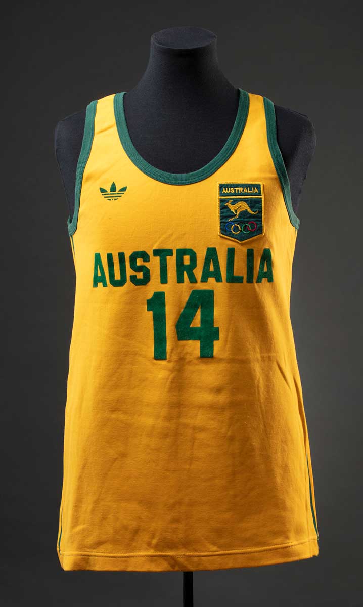 A yellow sports singlet with green striping on the sides; the number '14' in green on the front and back, as well as the text 'AUSTRALIA' on the front; and a green patch on the front featuring a design of a kangaroo and the Olympic rings symbol. - click to view larger image