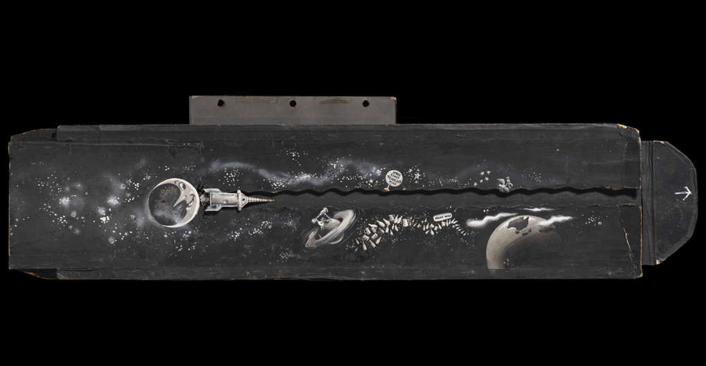A black and white rectangular panel showing a hand-painted galaxy. The outerspace scene has a moon towards the left and Earth on the right. Beside the moon is a rocket ship attached to a sliding panel.
