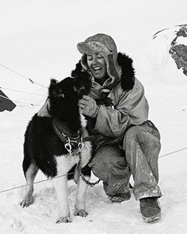 Portrait of Dr Diana Patterson OAM and a sled dog.