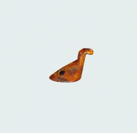 Bird figure made of bone that represents a water bird resting on a flat oval base.