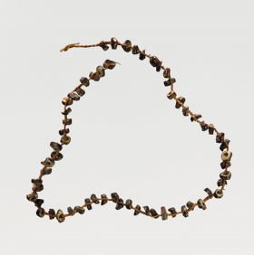 Necklace consisting of small wooden discs incorporated into a plaited string.