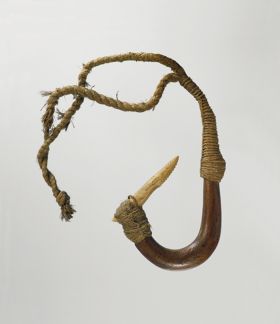 Fishhook with curved wooden shank, bone point, and lashing of twisted cords of plant material.