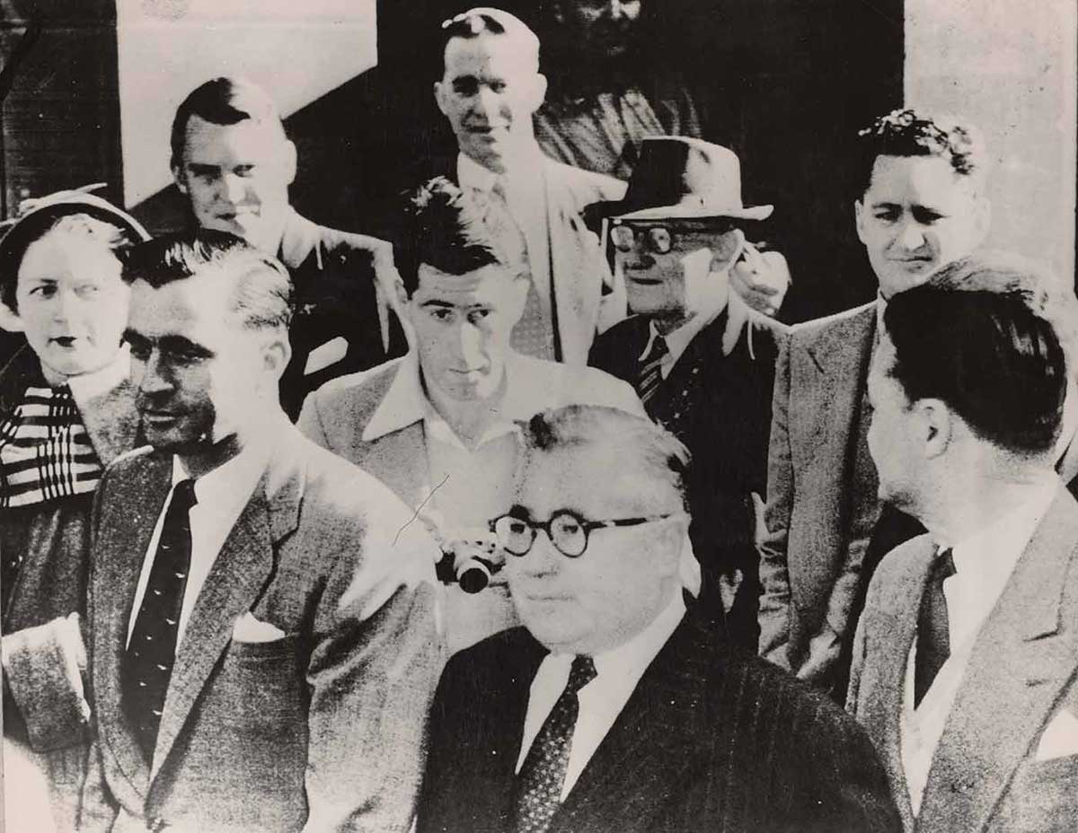 Photo showing mainly men in suits.