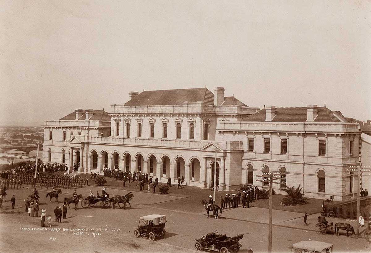 Vintage postcard of a large building with crowds of people gathered.