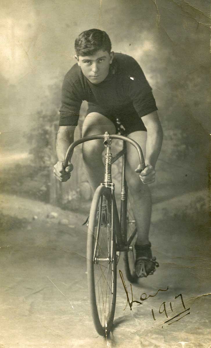 Black and white photograph of a man on a bicycle. - click to view larger image
