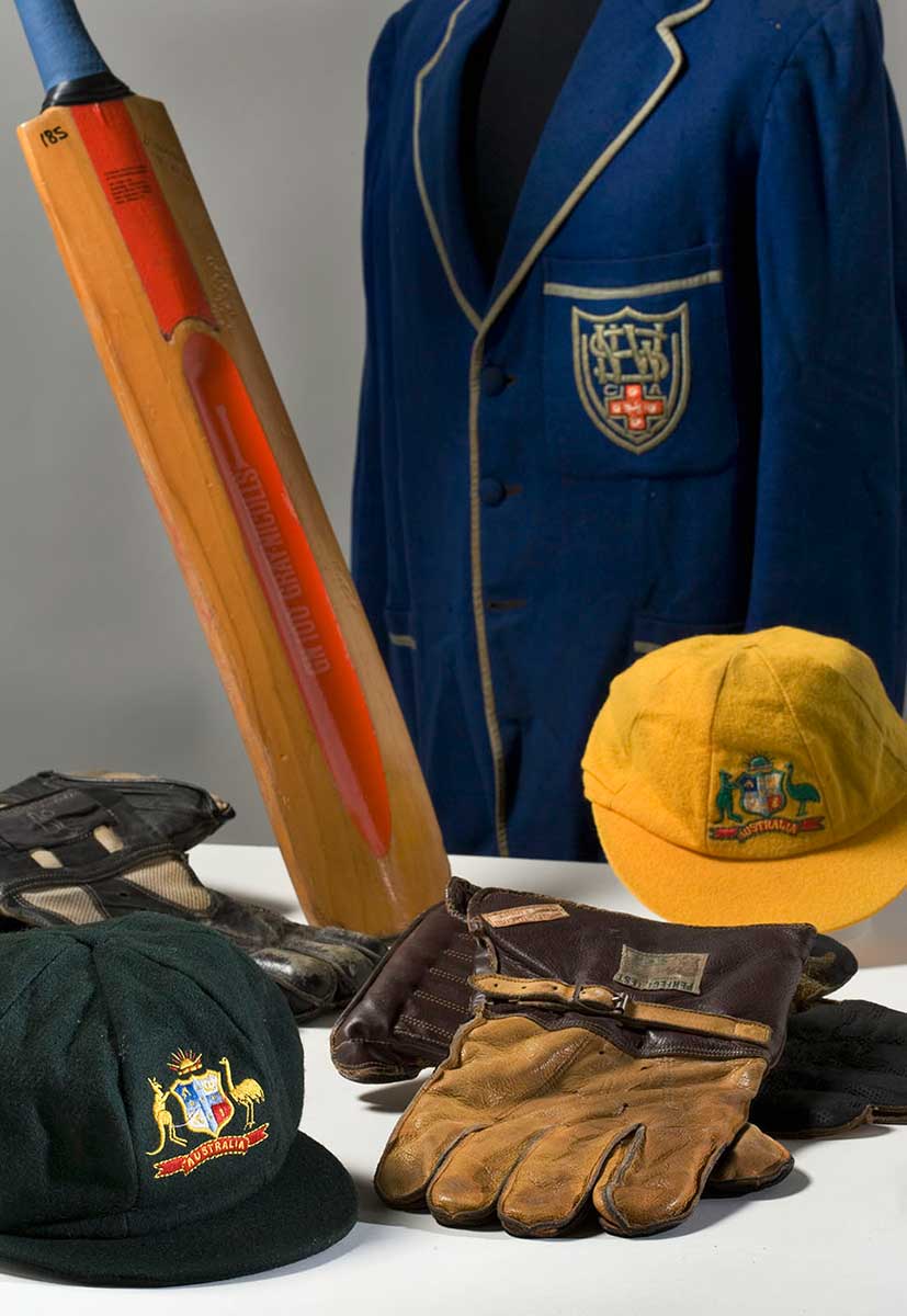 Cricket bat, blue blazer, caps and gloves. - click to view larger image