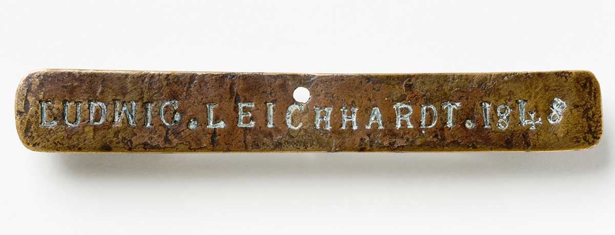 Long rectangular piece of brass with the words ‘Ludwig Leichhardt 1848’ stamped in it.