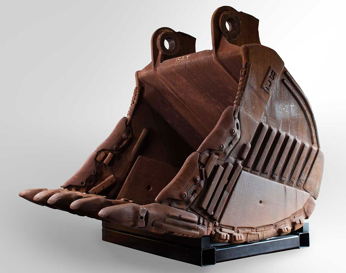 A rusty, concave-shaped iron bucket from a mining excavator. - click to view larger image