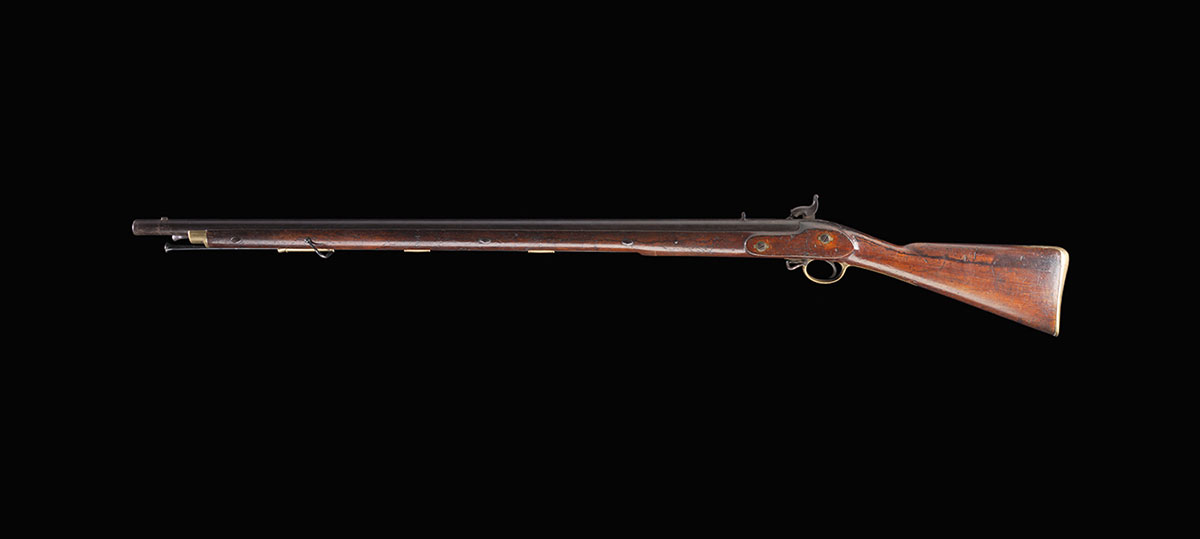 A long-barelled gun with a wooden stock and brass furnishings. - click to view larger image