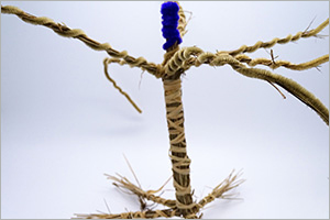 A woven artwork piece made from plant and man-made materials