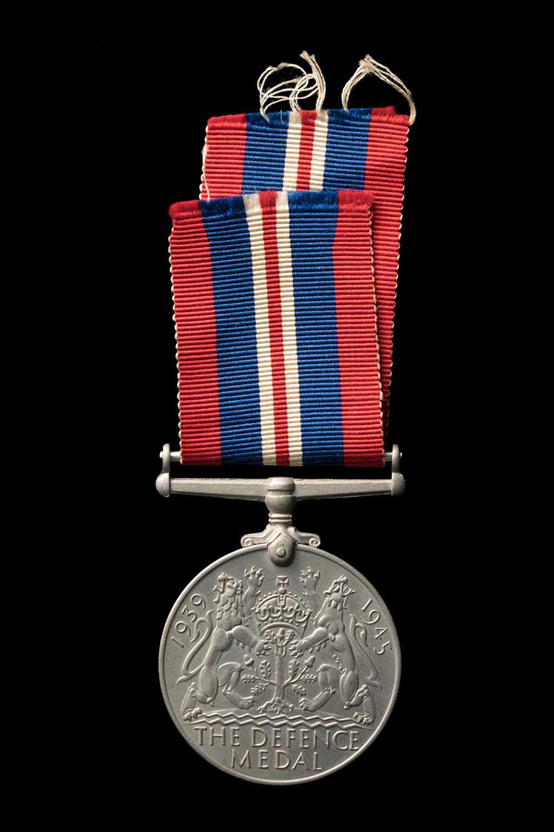 Medal with red white and blue ribbon on a black background. - click to view larger image