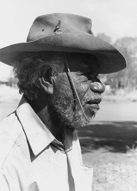 Side profile photo of an Aboriginal Australian man wearing a hat. - click to view larger image