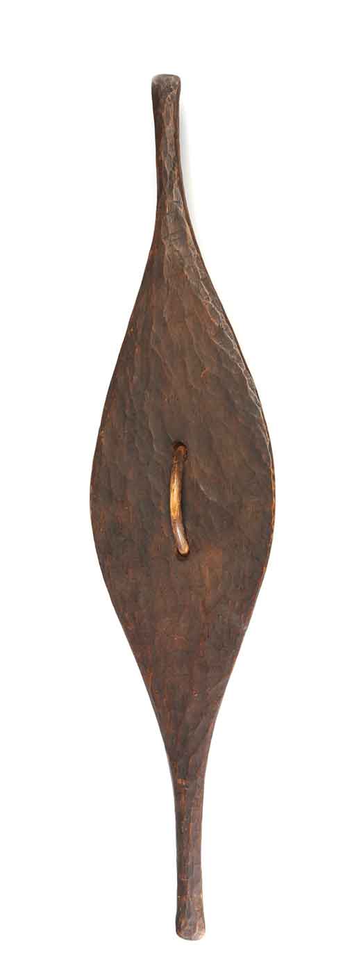 Back view of a long tear-drop shaped shield with tapered ends and wave design incised into surface. - click to view larger image