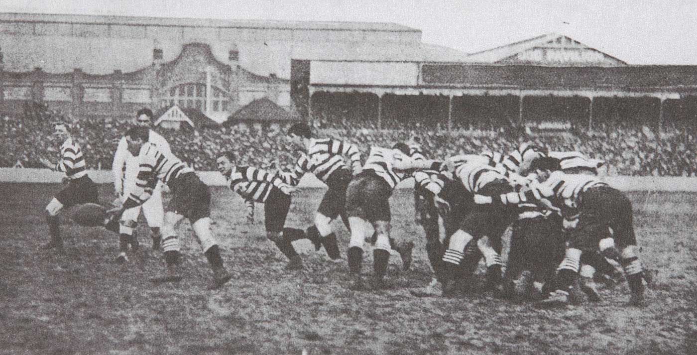 Rugby players competing on a field.