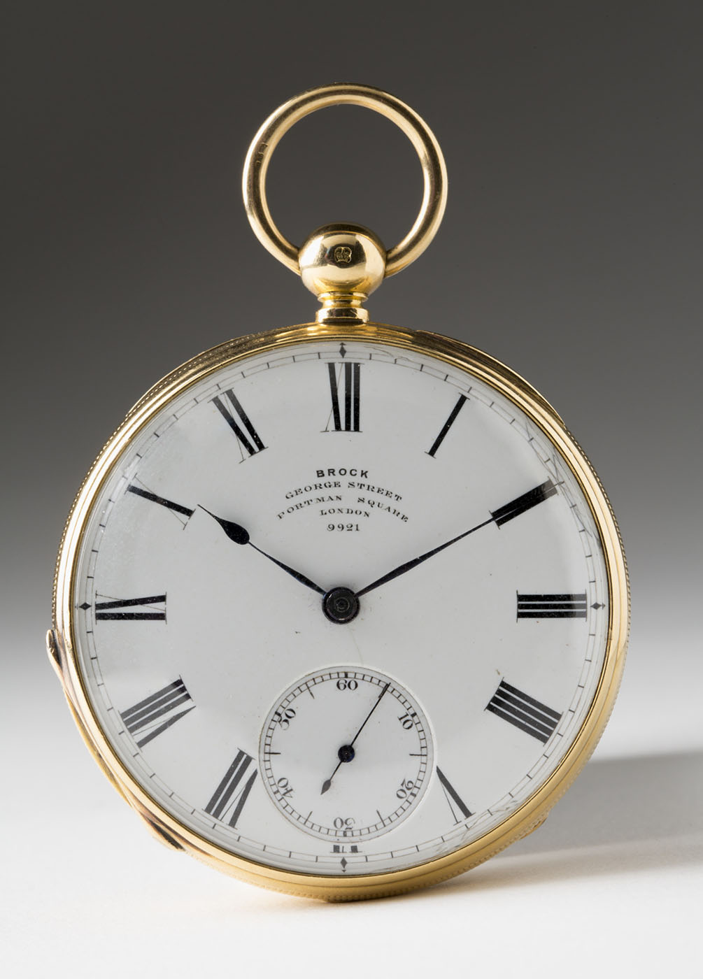 A gold pocket watch with roman numerals and text 'Brock, George Sydney' - click to view larger image