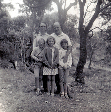 A black and white photograph of the Pollak family in a bush setting. - click to view larger image