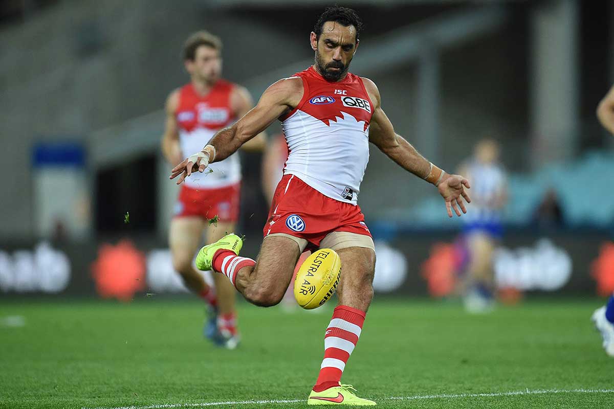 Colour photo of Adam Goodes on the football field about to kick a ball.