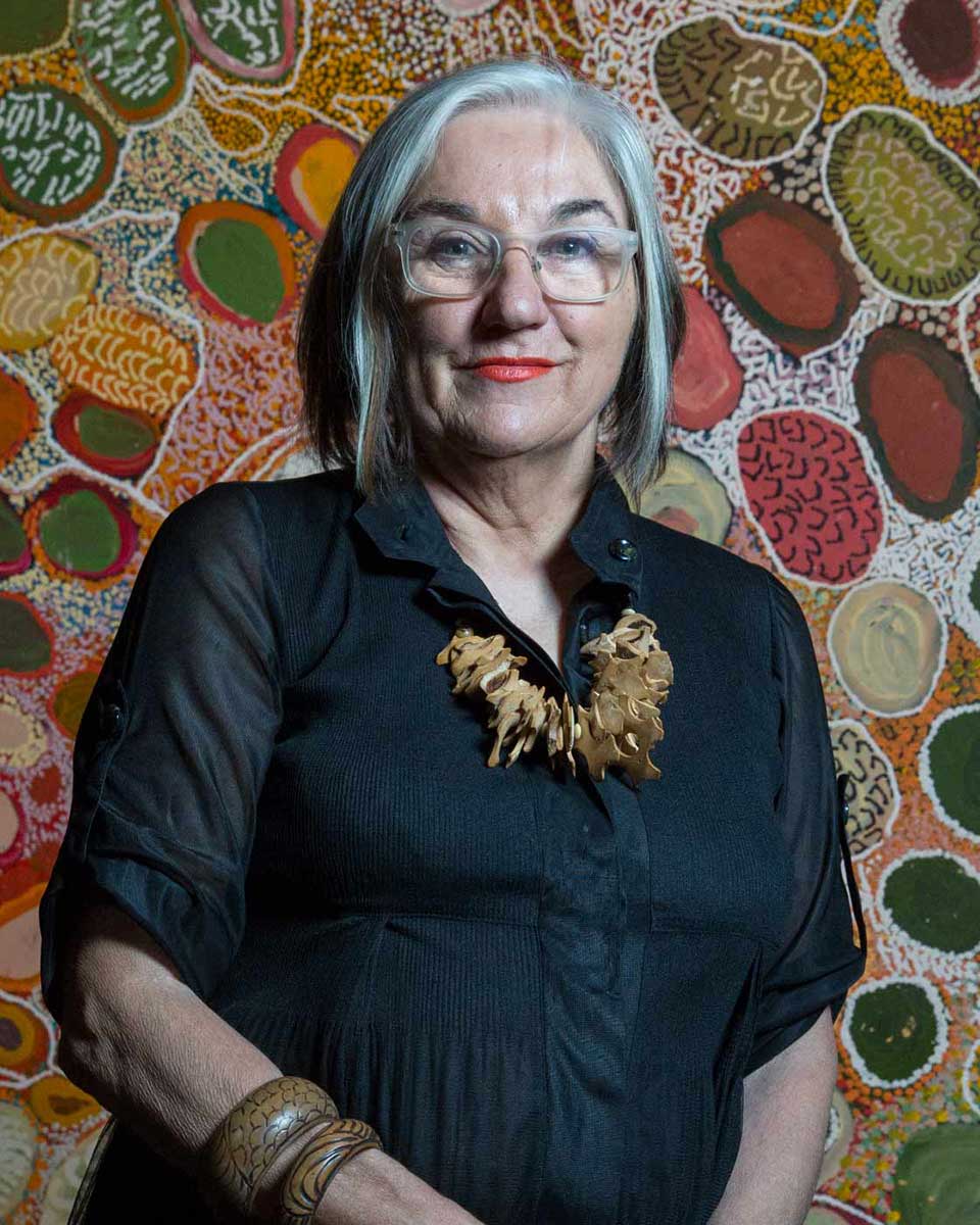 Portrait of a woman standing in front of a painting. - click to view larger image