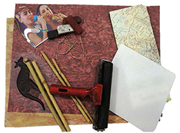 Suggested materials for use in making a collage including a brown card, sticks, string, a paint roller, a map and photos.