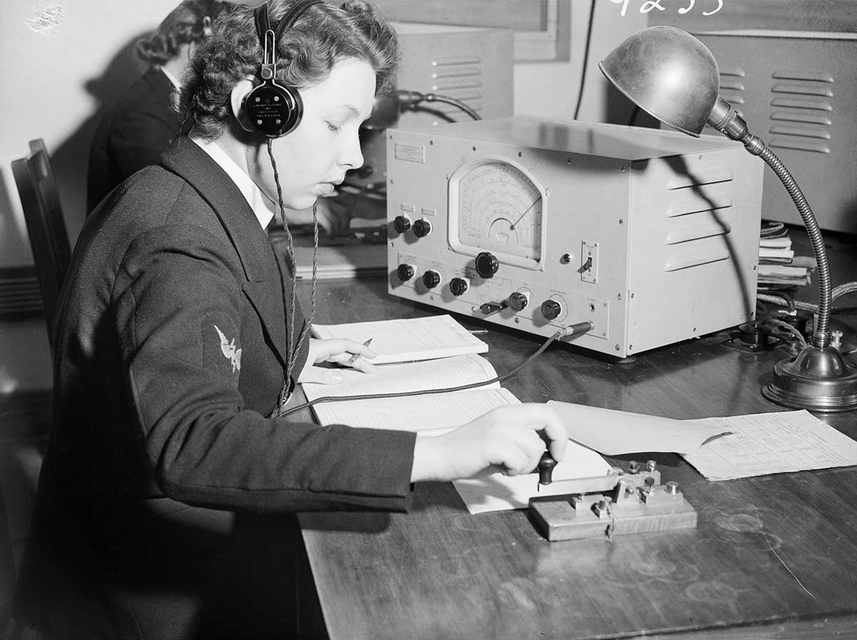 Black and white photograph of a women in military uniforms with communication equipment. - click to view larger image