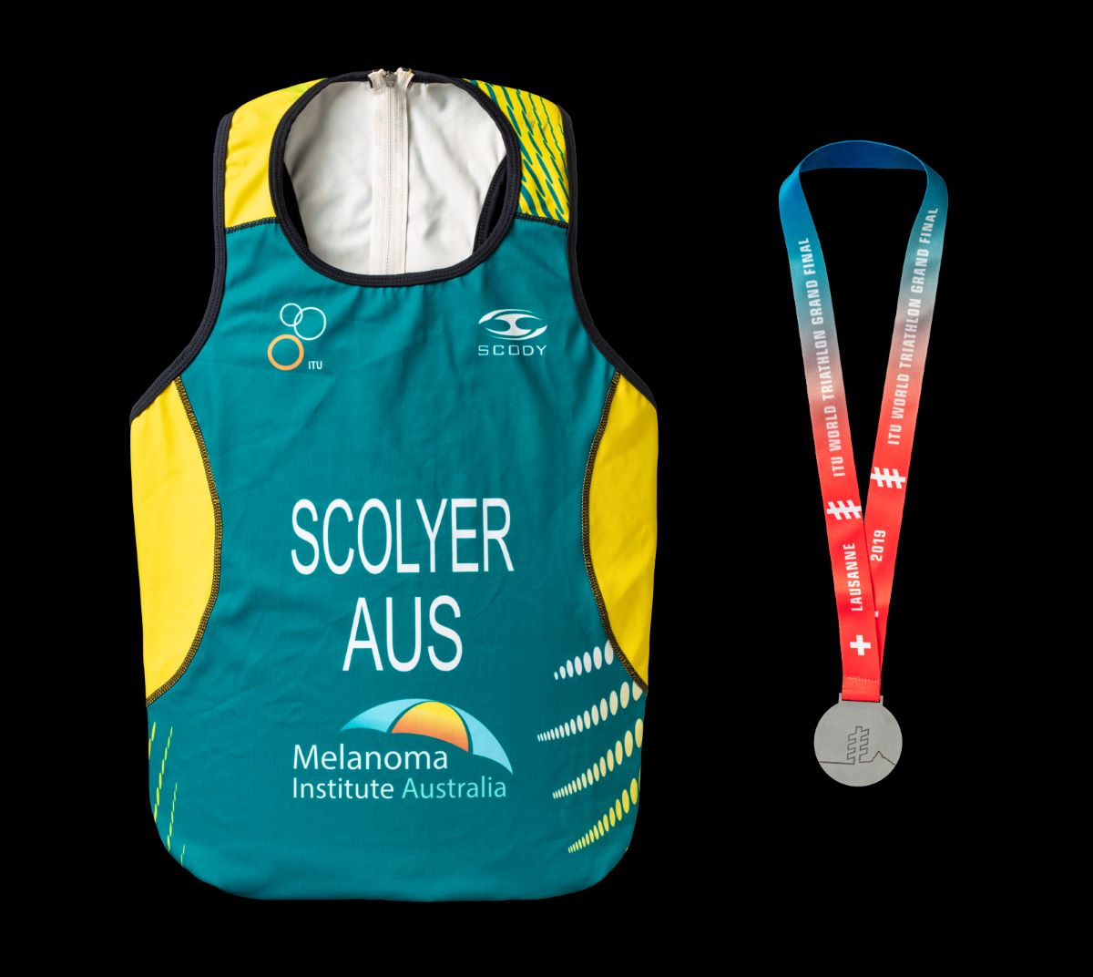 Photo of a triathlon medal and suit - click to view larger image