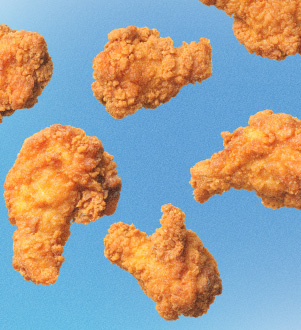 Friend chicken wings and drumsticks on a blue background.