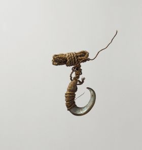 fishhook made of snail shell with thin twisted cord.