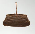 Basket made of ‘alu (a native creeper with tendrils) and coconut fibres with an oval opening, in a dark brown colour.