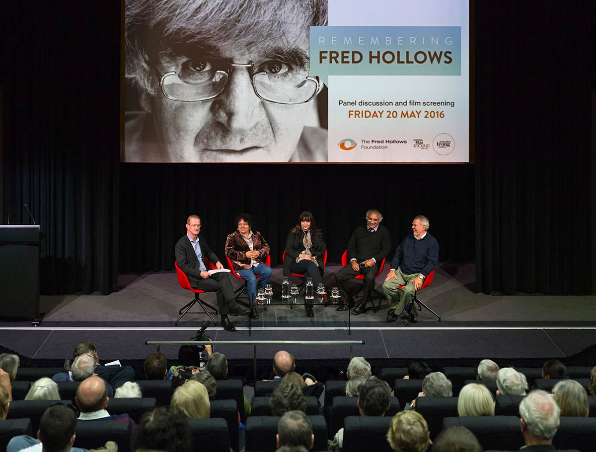A group of people on stage in front of an audience.
