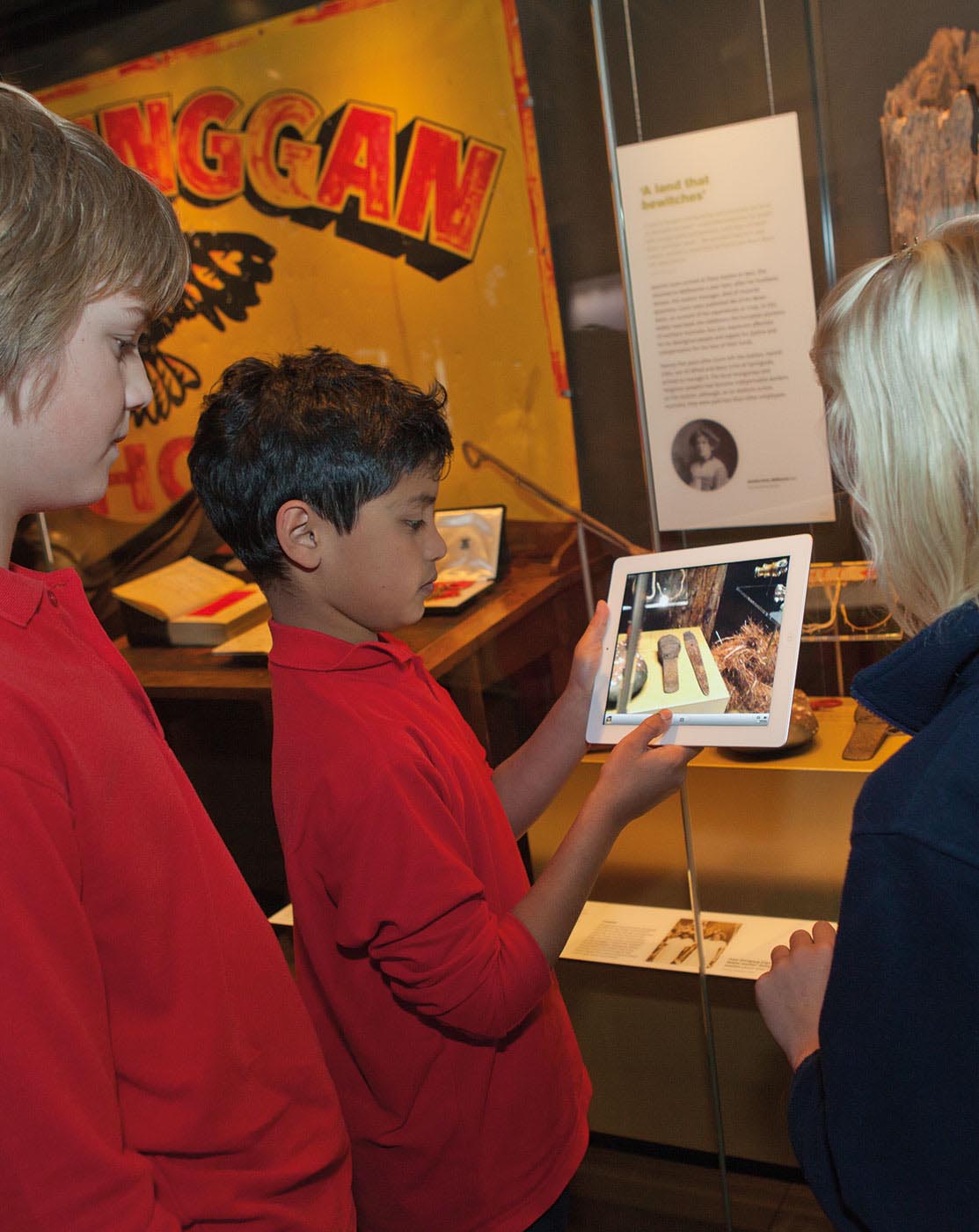 A colour image of students playing a game on an iPad.