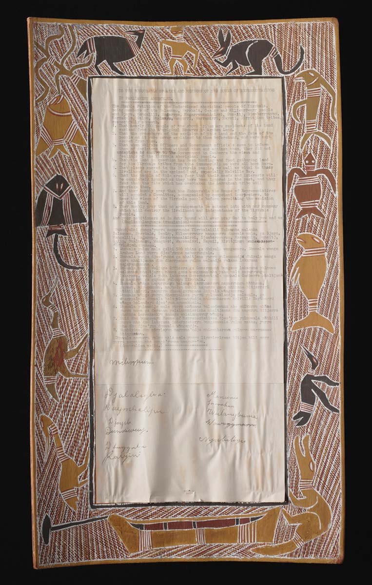 A rectangular bark painting that forms a border around a typed petition on paper. The bark is painted with yellow, white, brown, red, and black ochre. The border depicts birds; a man; a kangaroo; a turtle; a dugong; a crocodile; a stingray; fish; birds; and a canoe on a background of cross-hatching. The petition is stuck to the centre of the bark and has a heading that reads 'TO THE HONOURABLE SPEAKER AND MEMBERS OF THE HOUSE OF REPRESENTATIVES / IN PARLIAMENT ASSEMBLED. - click to view larger image