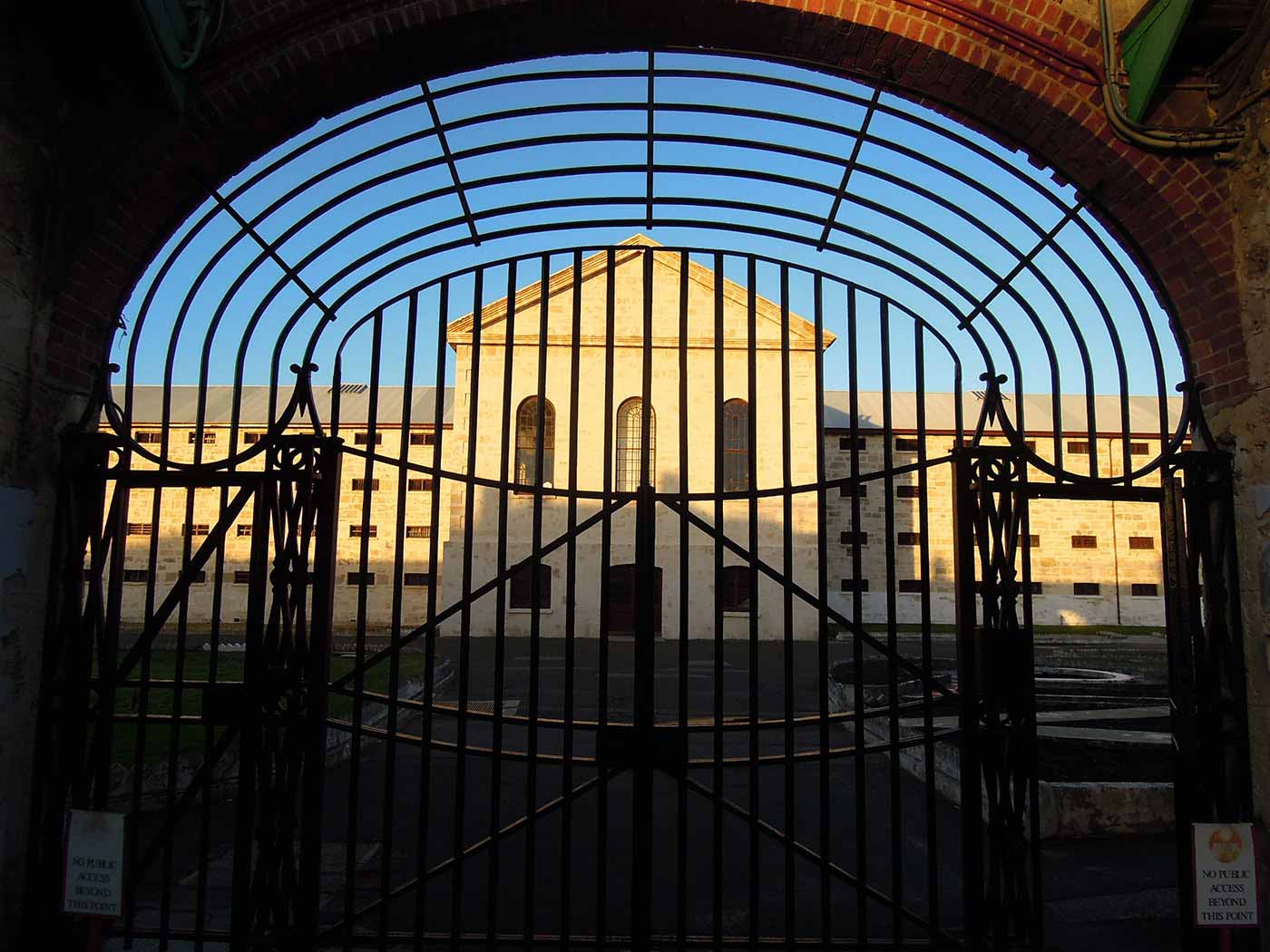 View of a heritage building through arc-shaped gates.