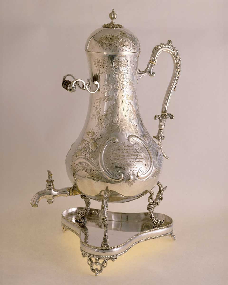 Silver coffee urn on silver stand. - click to view larger image