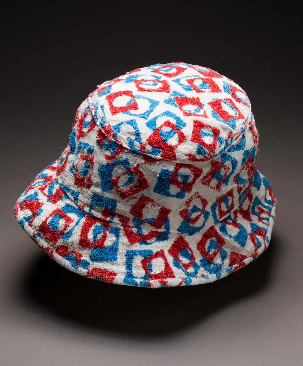 Hat made from Terry towel fabric featuring an abstract design of red and blue squares with circles in the centre. - click to view larger image