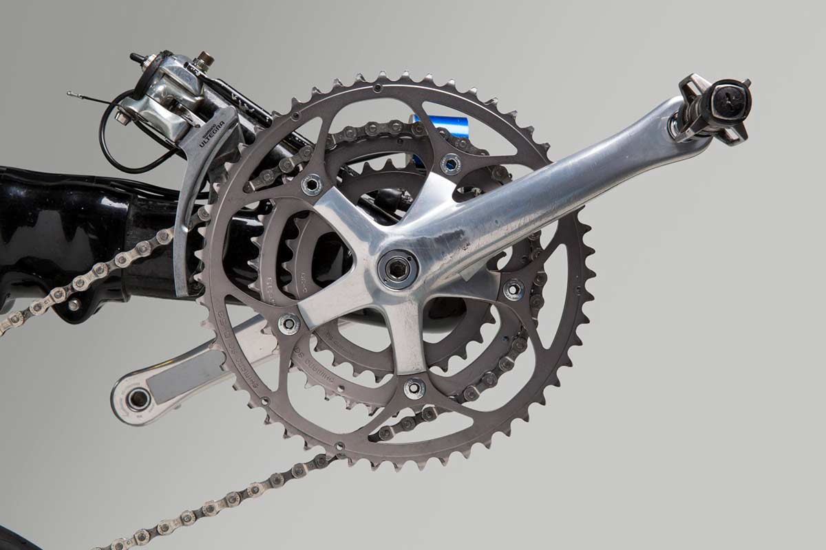 Colour photo showing a close up view of the crank set and pedals on a bike. - click to view larger image