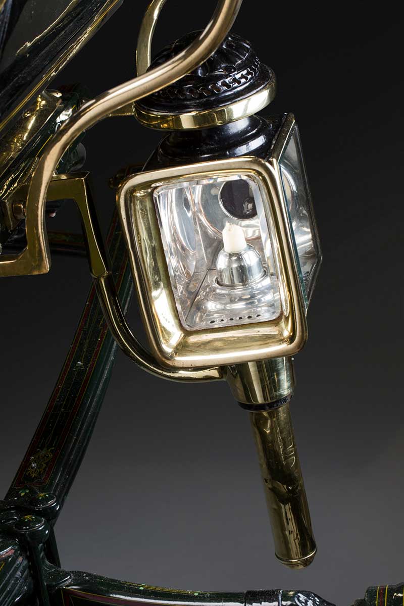 A small glass lamp on the side of a carriage. - click to view larger image