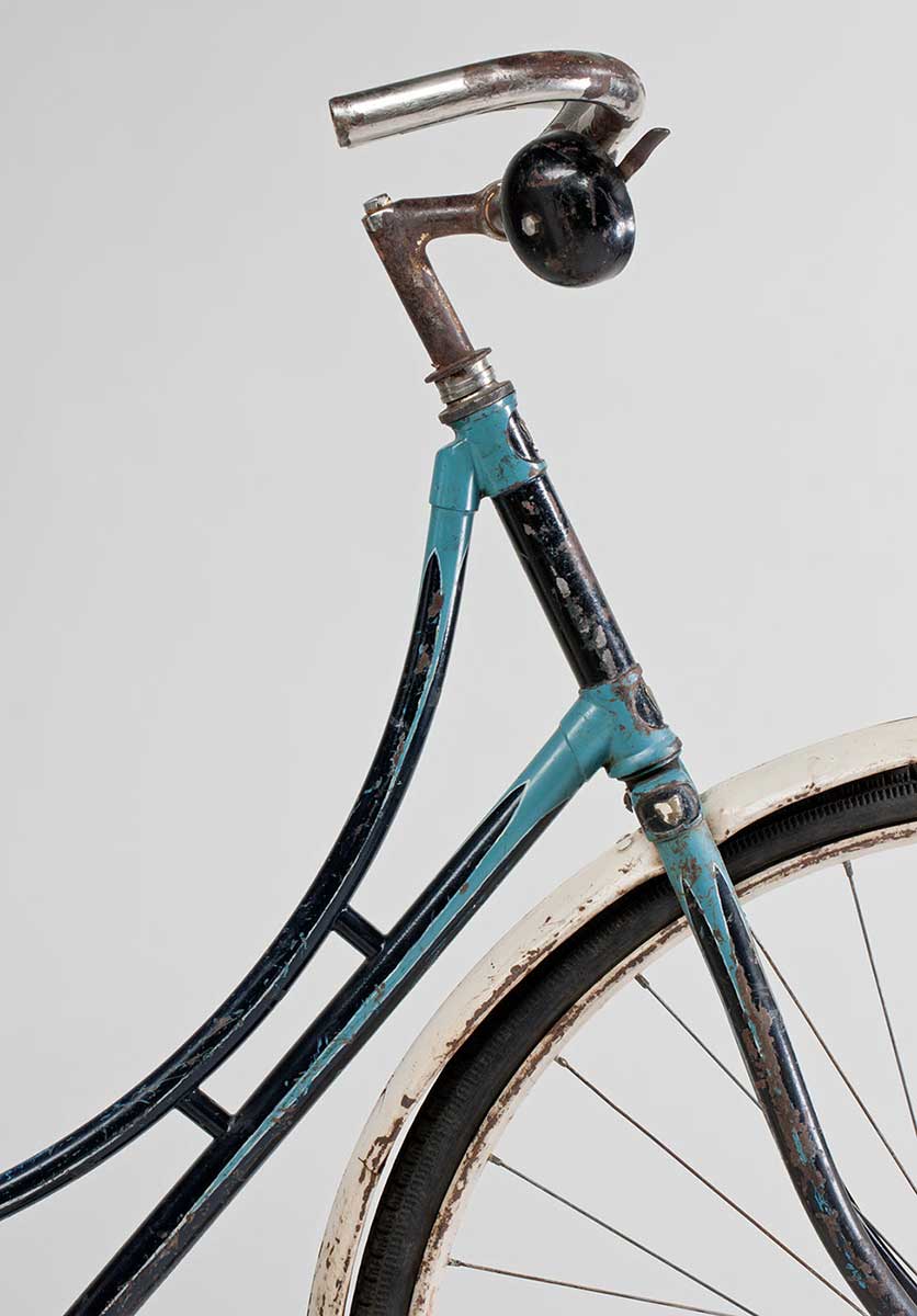 Large black bell on right side of the handlebar and frame painted in two shades of blue. - click to view larger image