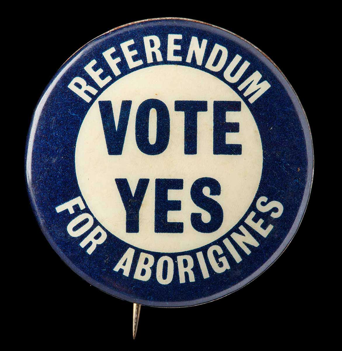 atA circular metal badge with a navy blue border with white text reading, 'REFERENDUM FOR ABORIGINES'. The centre of the badge reads: 'VOTE YES'. - click to view larger image