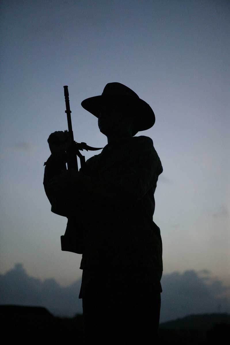 Dark figure of an australian soldier against background of dawn sky. - click to view larger image