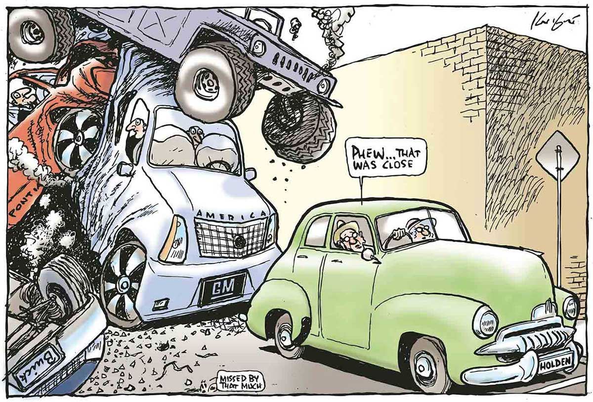 A colour cartoon depicting an elderly couple in an old green FJ 'Holden' stopped at an intersection, with a wrecked traffic scene piled up behind them. A 'GM' 'America' truck has been hit by a smoking Hummer, a wrecked 'Pontiac' and a 'Buick' which has come to rest on its roof. The hat-wearing male Holden driver says, 'Phew that was close'. A small figure in the foreground says, 'Missed by that much'. - click to view larger image