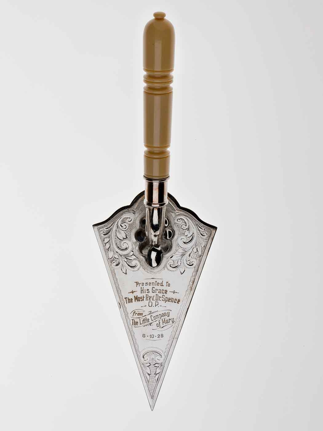 Silver ceremonial trowel with engraved text and ornate borders. - click to view larger image