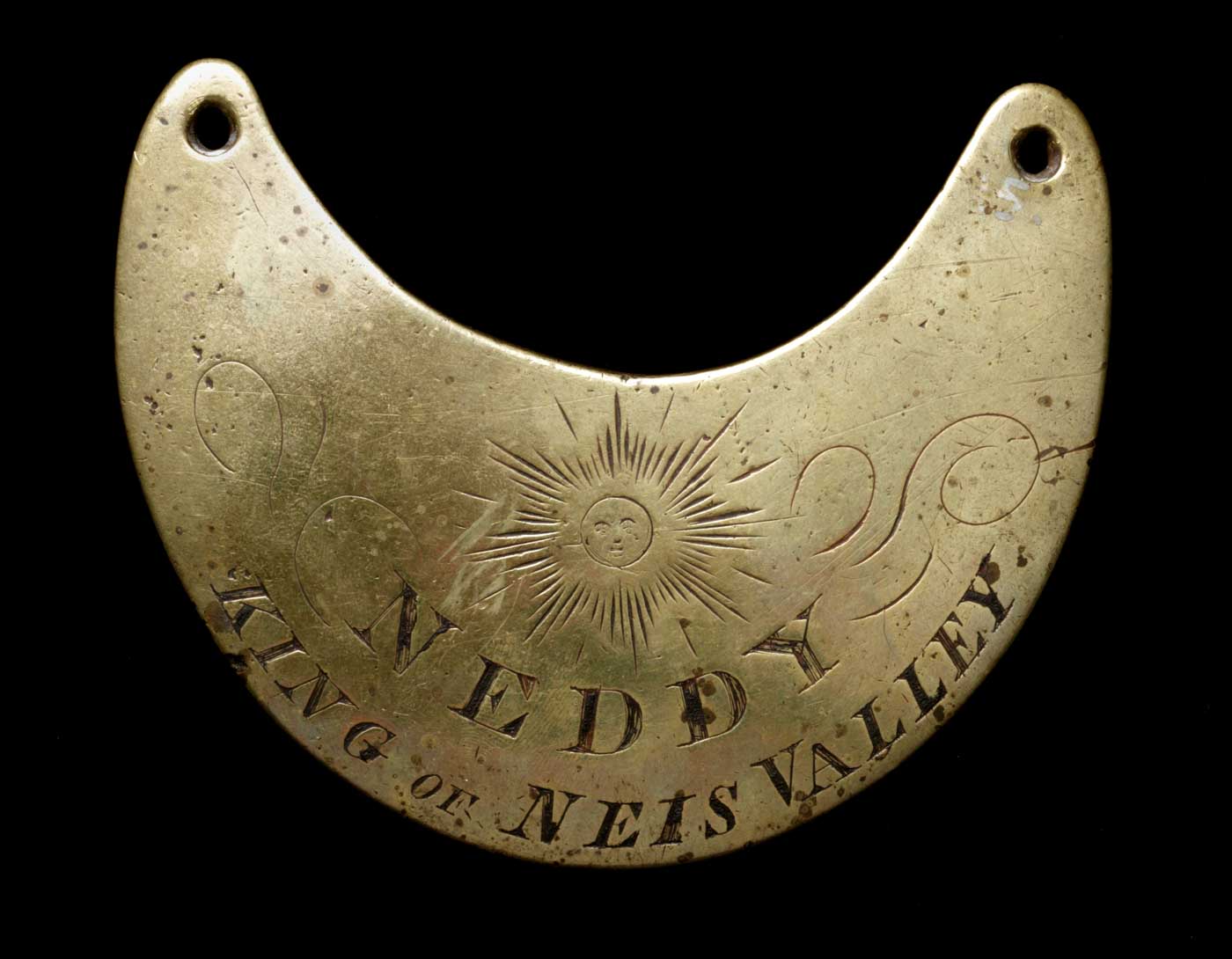 Engraved breastplate with an image of the sun engraved top centre.